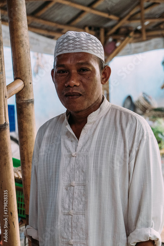 Indonesian Middleaged man runs a fish business on local market photo