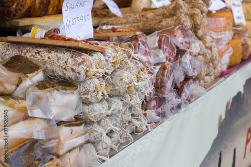 seasoned salami and hams to be sold photo