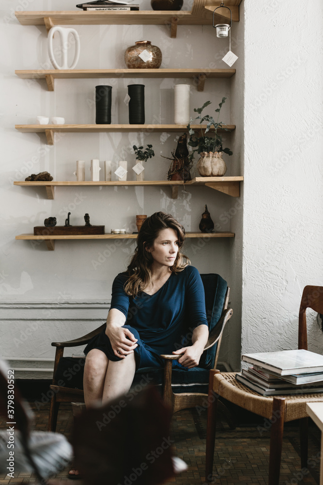 portrait of woman sitting in studio shop