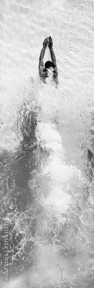 Black and white aerial of swimmer diving in pool Black and white aerial of swimmer diving in pool