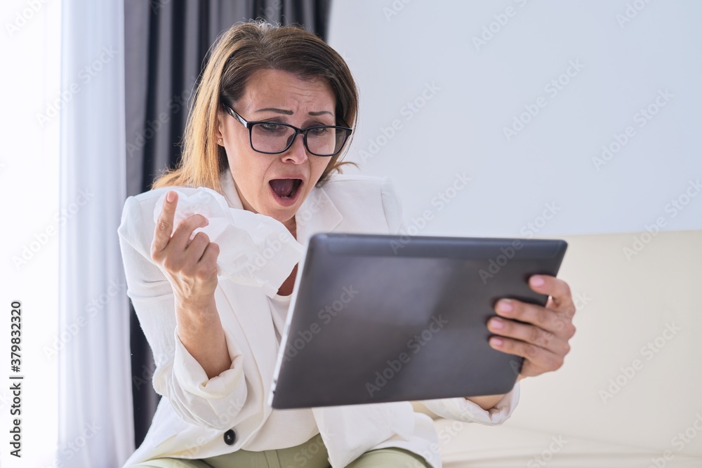 Sick businesswoman sneezing in handkerchief making video call