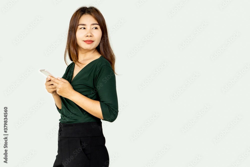 beautiful Asian business woman hand holding mobile phone standing over gray background beautiful Asian business woman hand holding mobile phone standing over gray background