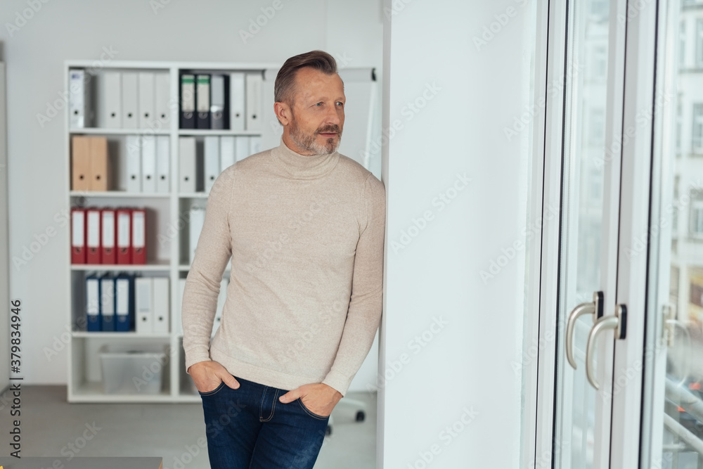 Trendy businessman standing deep in thought Trendy businessman standing deep in thought