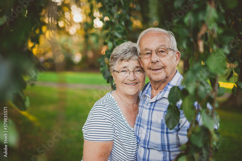 Cute elderly couple smiling together outside