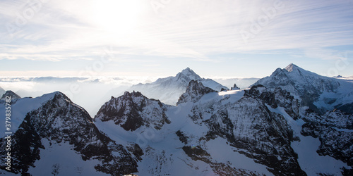 Panorama of Fleckistock mountain peak above cloudscap photo