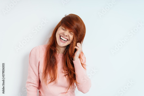 Cute vivacious playful young redhead woman