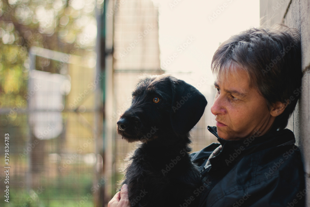 Woman and dog look at something with funny and suspicious look Woman and dog look at something with funny and suspicious look