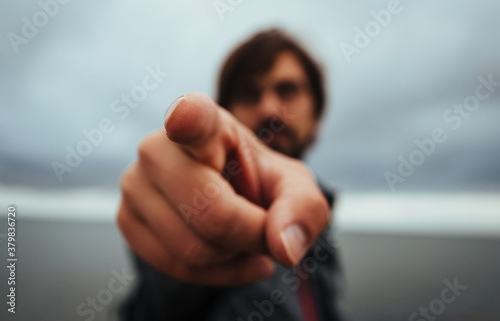 Man Pointing in the Direction of the Camera, Shallow Depth of Field