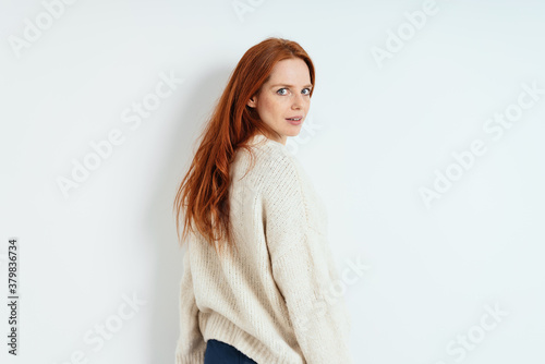 Fotografie Young redhead woman looking quizzically back
