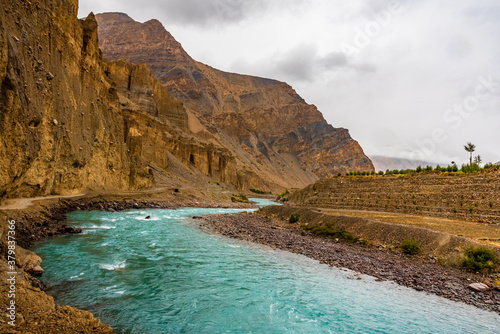 View enroute to Kaza through barren cold desert landscape of Spiti mountain valley located high in rain shadowed region of Himalayas in Himachal Pradesh, India.