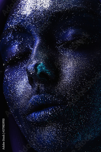 space woman in blue paint and glitters