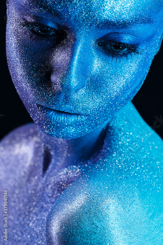 magic woman with blue body art with glitters