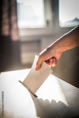 Conceptual image of a person voting during elections photo