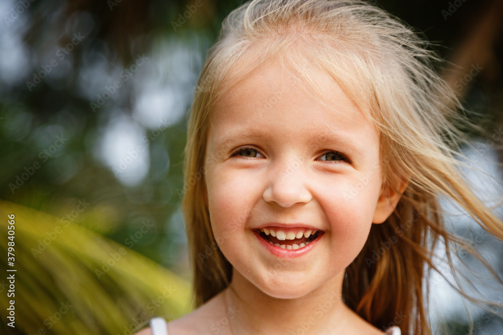 Portrait of happy little girl with smile. Summer vacations concept, dental hygiene, health insurance, tropical vibes. Kid smiling Portrait of happy little girl with smile. Summer vacations concept, dental hygiene, health insurance, tropical vibes. Kid smiling