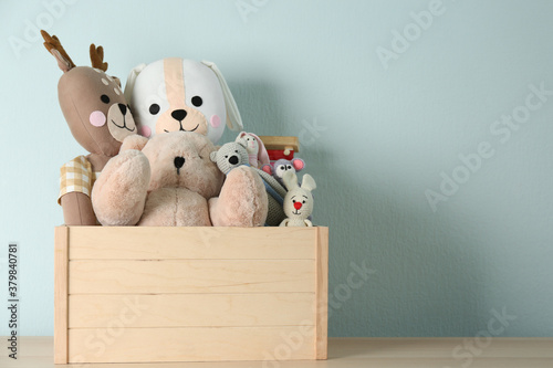 Canvas Print Crate with different toys on wooden table. Space for text