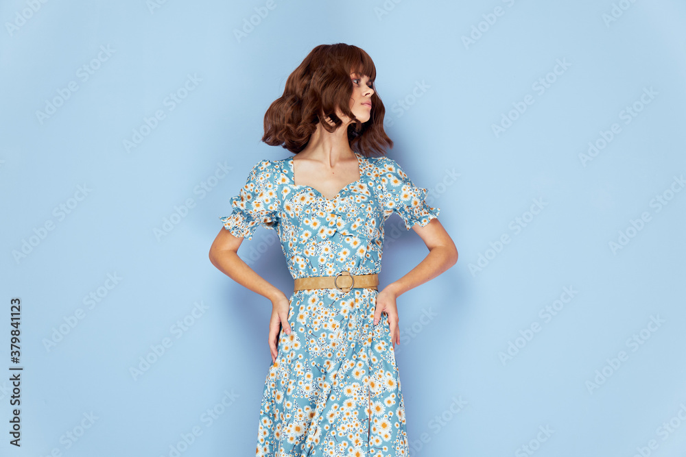 Pretty woman Looks to the side of the hand on the belt summer clothes 