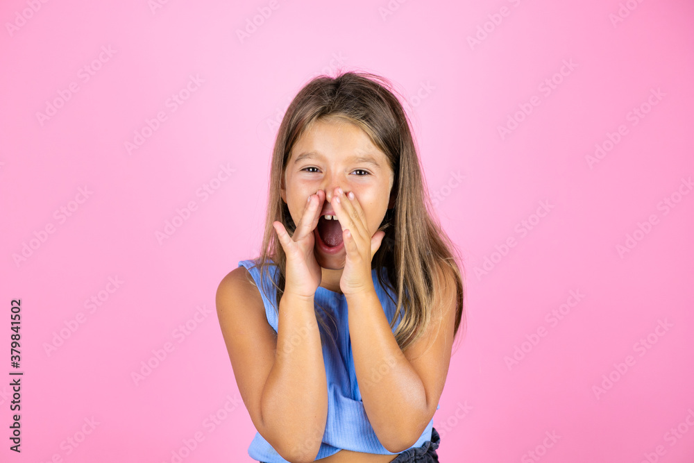 Young beautiful child girl over isolated pink background shouting and screaming loud to side with hands on mouth Young beautiful child girl over isolated pink background shouting and screaming loud to side with hands on mouth