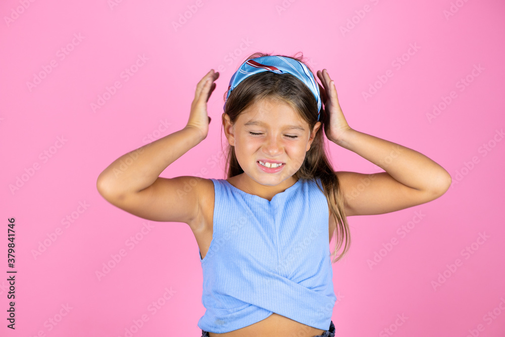 Young beautiful child girl over isolated pink background suffering from headache desperate and stressed because pain and migraine with her hands on head Young beautiful child girl over isolated pink background suffering from headache desperate and stressed because pain and migraine with her hands on head
