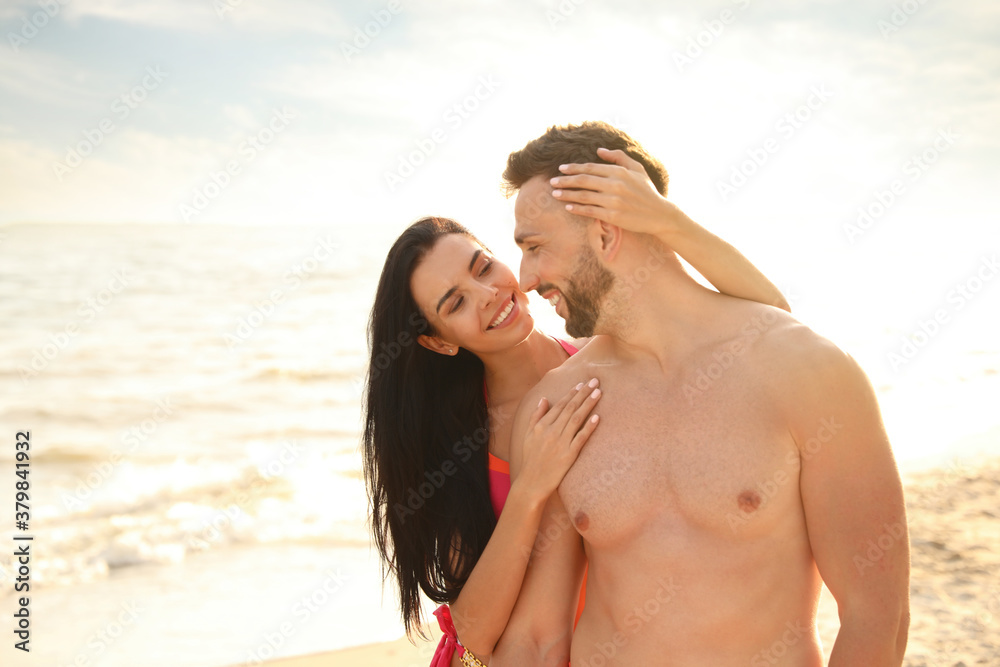 Happy young couple on beach on sunny day Happy young couple on beach on sunny day