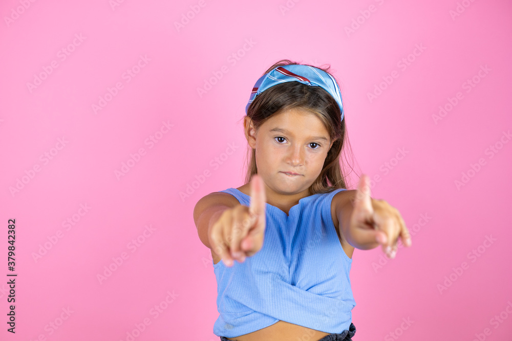 Young beautiful child girl over isolated pink background saying no with fingers, angry and frustration expression Young beautiful child girl over isolated pink background saying no with fingers, angry and frustration expression
