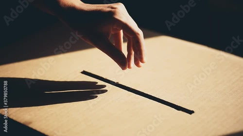 Conceptual footage of a person voting, casting a ballot at a polling station, during elections. photo