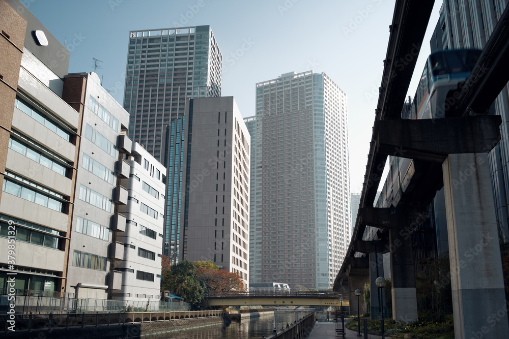Monoral zipping through an early morning waterfront residential area Tamachi, Tokyo.