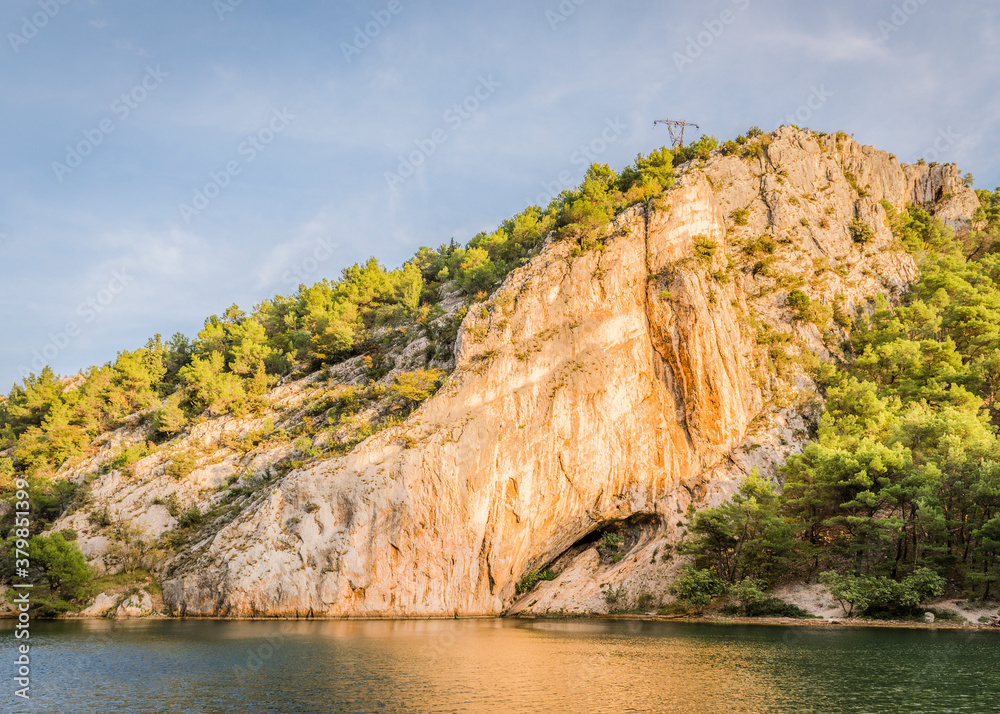 View of the steep mountain and the river Krka near the town of Skradin, Croatia