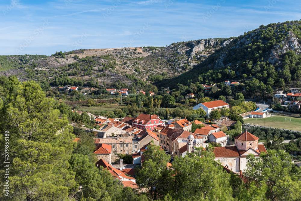 View of the town of Skradin, Croatia surrounded by forest and mountains