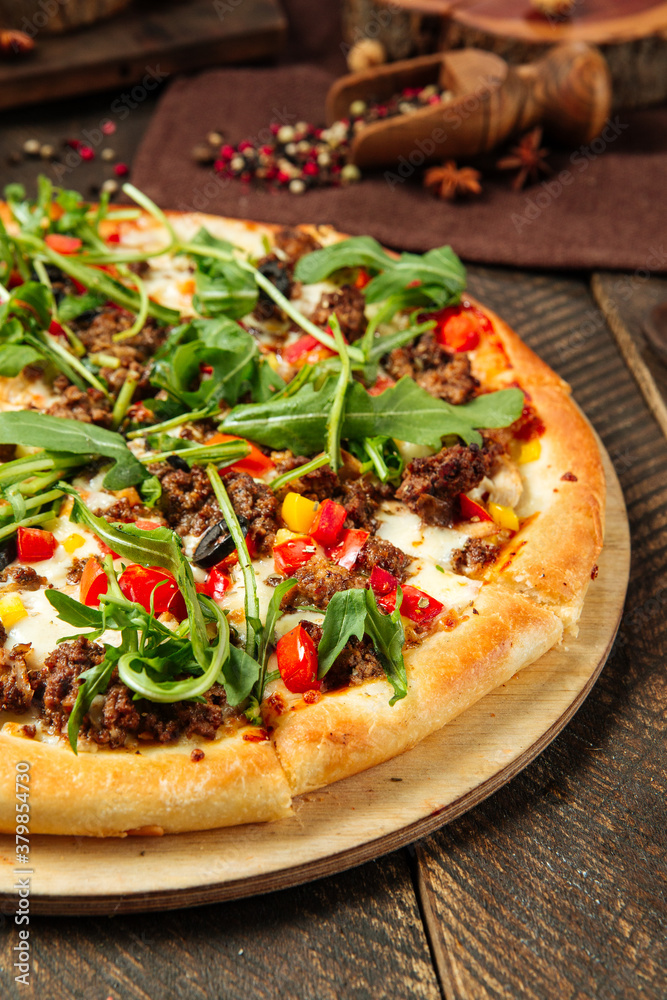 Closeup on pizza with minced meat and arugula Closeup on pizza with minced meat and arugula