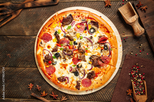 Assorted beef pizza with salami and vegetables