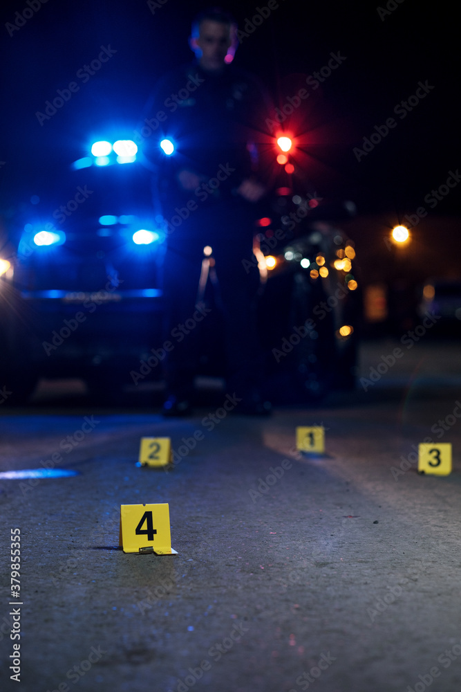 Shell casings are marked with evidence tags at a crime scene Stock ...