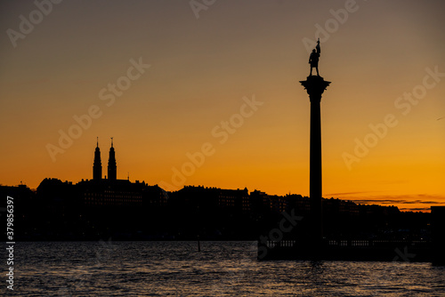 Crescent moon near the horizon. Behind the silhouette of the Stockholm skyline.