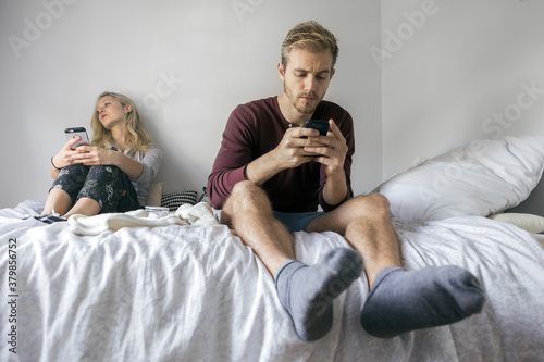 Girl is Bored while Boy is Busy Playing with His Phone