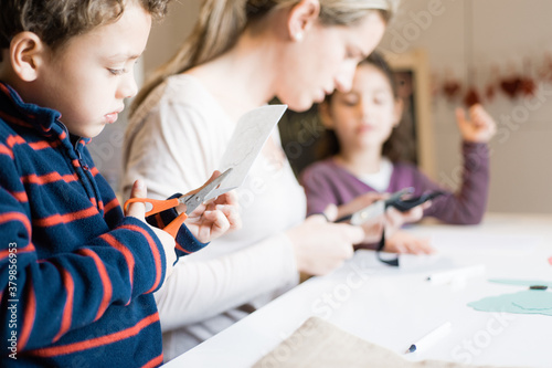 Wallpaper Mural A mother teaching her children to make Christmas decoration craf Torontodigital.ca