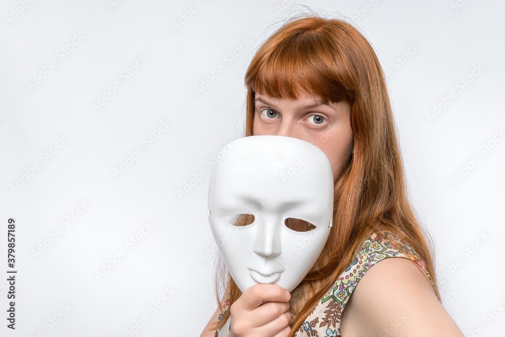 Mysterious woman cover her face behind anonymous mask фотография Stock |  Adobe Stock
