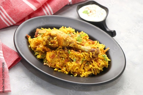 Chicken Biryani/murg Pulao.  Garnished with fried onion & chopped coriander. Biryani raita is a famous Spicy non vegetarian dish of India. Chicken cooked along with Basmati rice & spices. copy space.