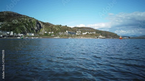 Estuary view of Barmouth in Wales seeing railway bridge and town in 4k 60fps