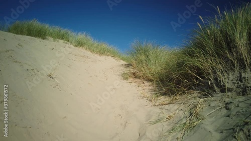 Climbing up sand dunes in the sunshine in 4K