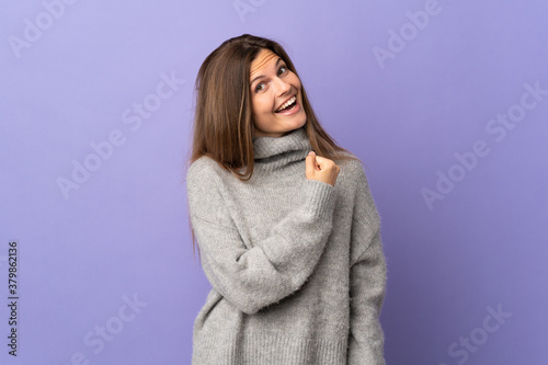 Young Slovak woman isolated on purple background celebrating a victory © luismolinero