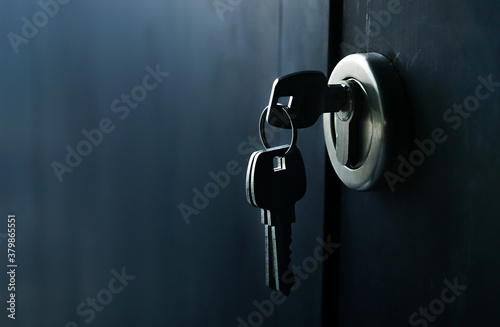 Selective focus/Keys stuck in a lock with door. photo