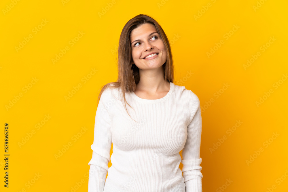 Young Slovak woman isolated on yellow background thinking an idea while looking up Young Slovak woman isolated on yellow background thinking an idea while looking up