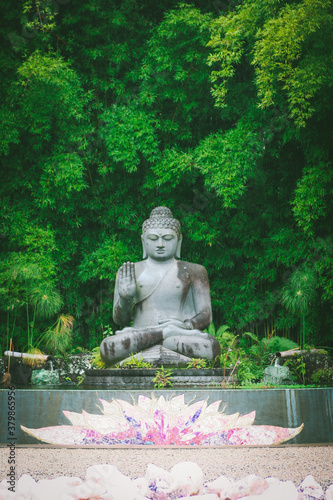 Buddha statue in zen meditation garden photo