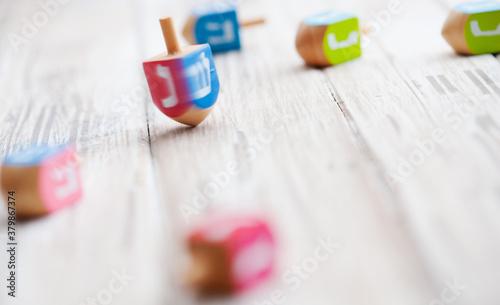 Holidays: Spinning Dreidel On Wooden Table photo