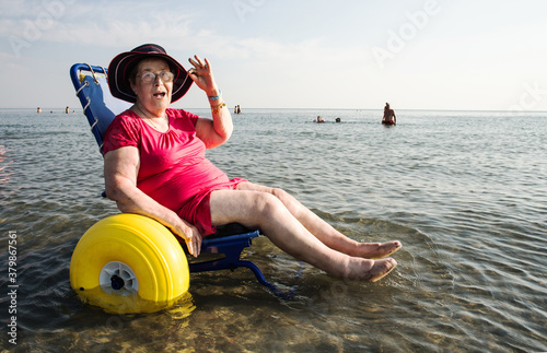 Senior lady on a special wheelchair for the beach