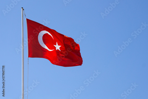 blue sky and the turkish flag waving in the wind