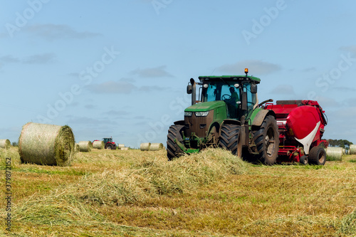 Hay Baling machine working on farmland photo