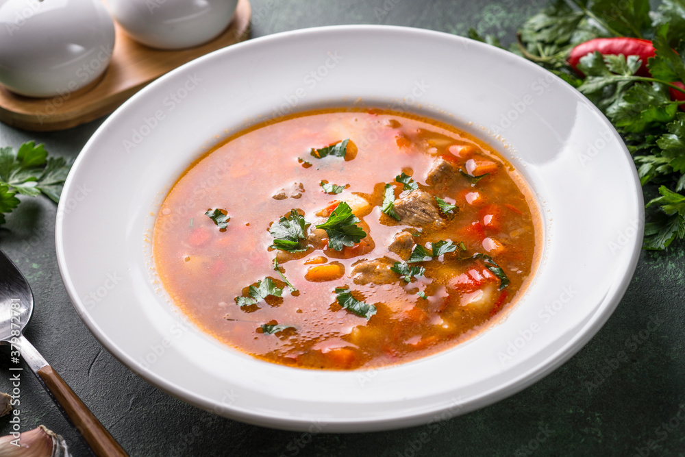 Traditional Hungarian goulash soup on the table. Traditional Hungarian goulash soup on the table.