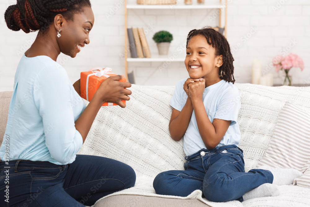 Mother congratulating her daughter, making surprise at home Mother congratulating her daughter, making surprise at home