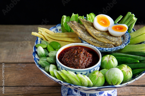 Fried chili paste, eaten with vegetables and fried fish, with boil egg (thai called nam prik pao), Thai food on tile tray