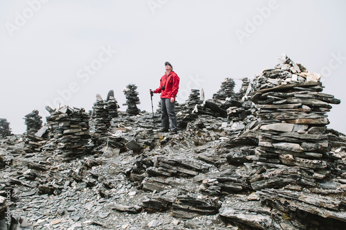 Female trekker on the lower summit of Chhukung Ri Peak, waiting for the sun to come out, Nepal. photo